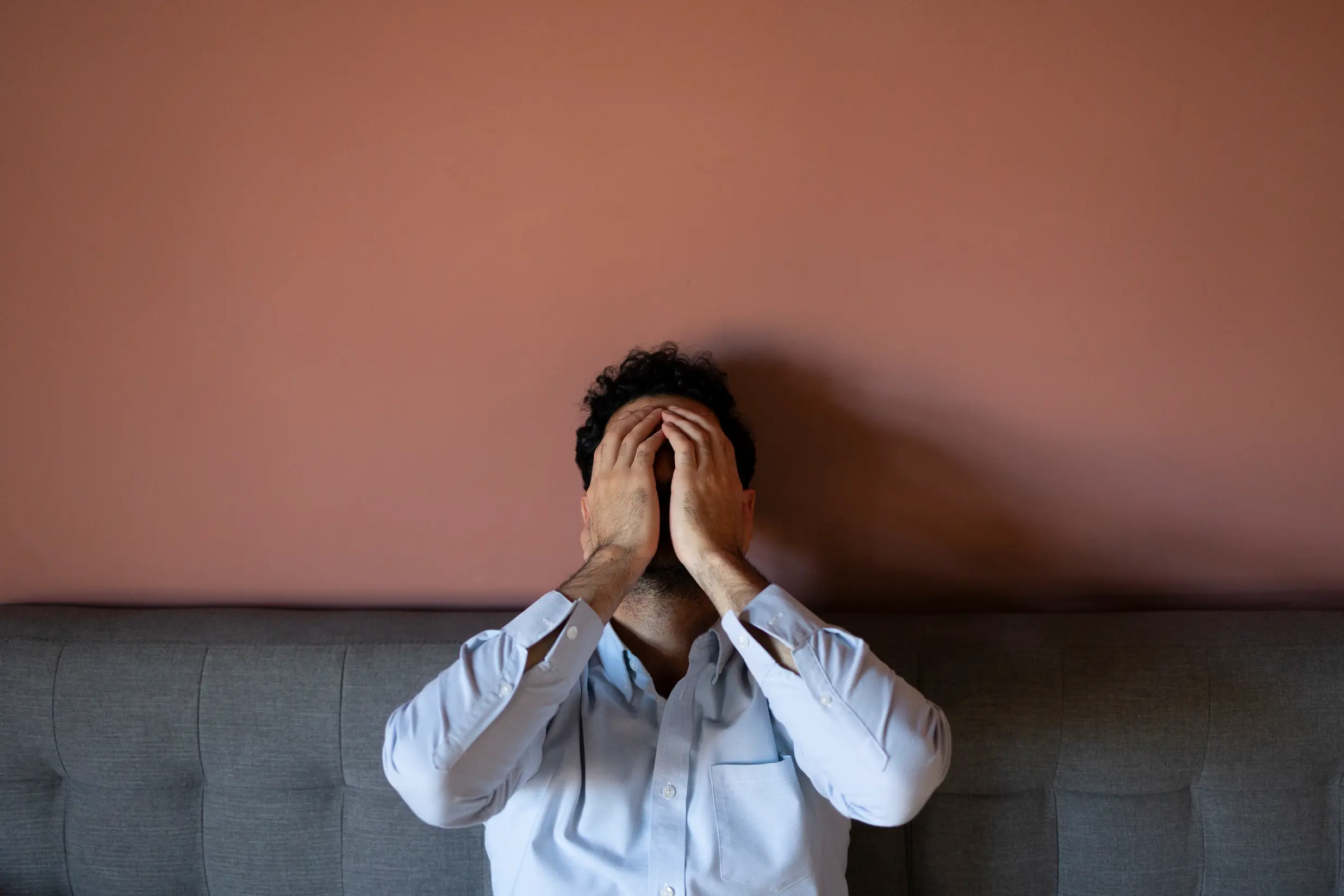 frustrated-man-couch-front-view